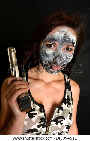 sexy woman with gun with camouflage painting