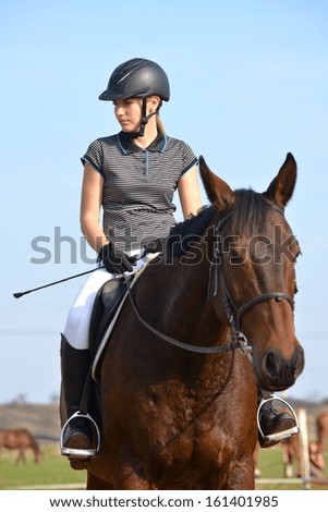 Young girl jumping with horse