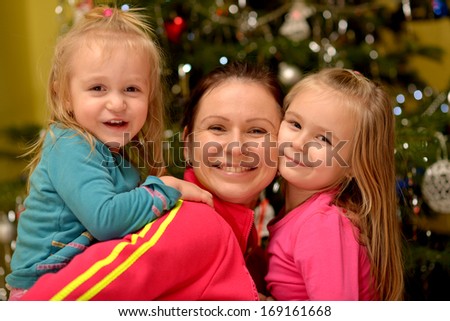 Young mother and her daughters on Christmas