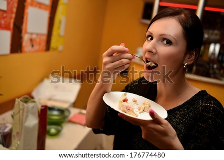Cheerful woman eating pie