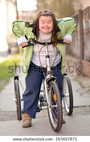 woman with down syndrome riding bike tricycle