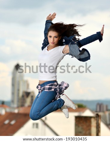 young beautiful dancer jumping on sky