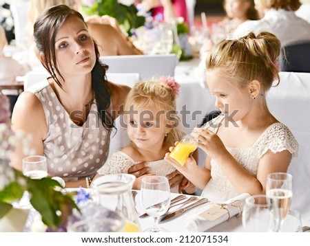 Cute little girl drinks orange juice using drinking straw