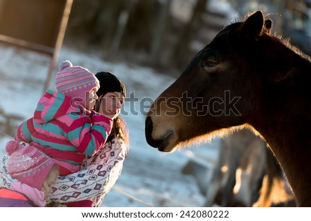 mother with baby love Horse gallops in winter