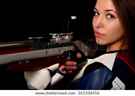 Woman training sport shooting with air rifle gun