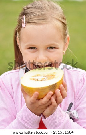 cute happy little girl with melon