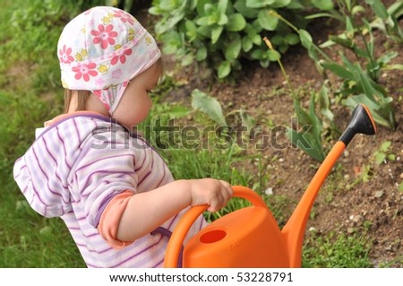 girl watering flowers in the garden