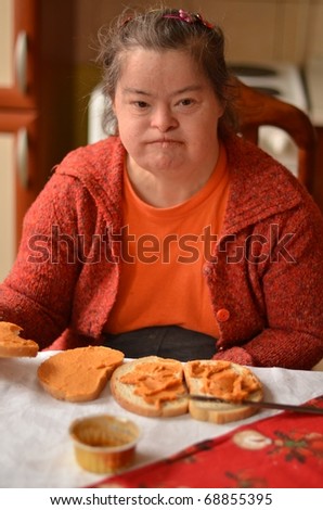 stock-photo-down-syndrome-woman-eating-68855395.jpg