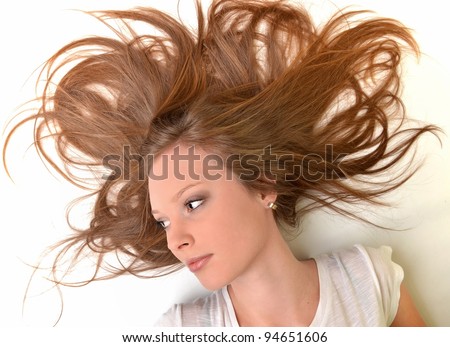 Pretty woman with long straight brown hair looking at camera, isolated on white background