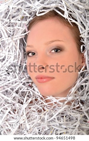 Young woman covered by shredded papers