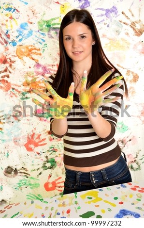 Creative activity. Woman with hands painted in colorful paints ready for hand prints .
