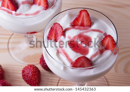 strawberry yogurt with strawberries on a wooden background