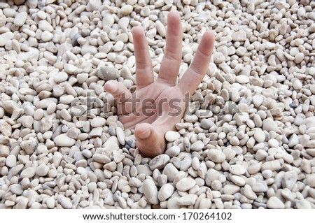 Hand out of tiny pebbles.