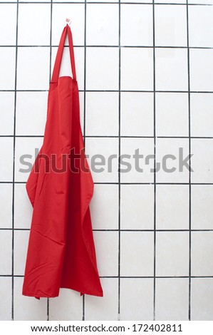 Red Apron Hangs On Wall.
