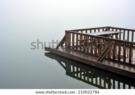 Lake dock on a misty day.