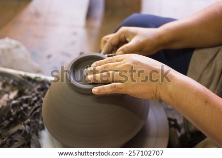 Close up hands of a potter, creating an earthen jar for Ceramic export to Japan