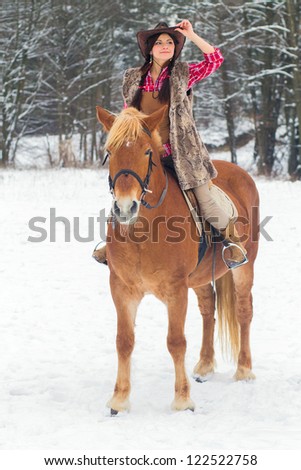 Attractive Young Woman Riding a Horse the Snow