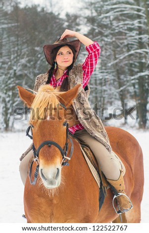 Attractive Young Woman Riding a Horse the Snow