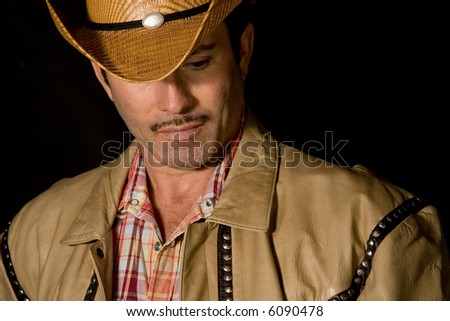 A cowboy posing for fashion.