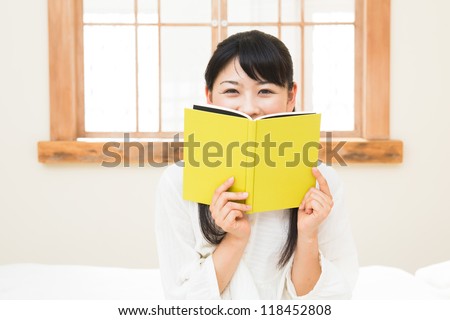 The woman who reads a book in the bedroom