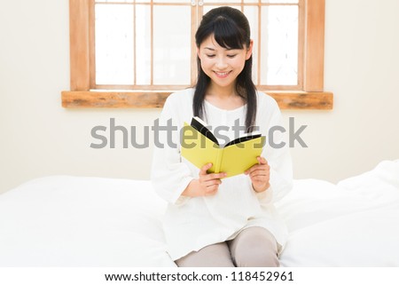 The woman who reads a book in the bedroom