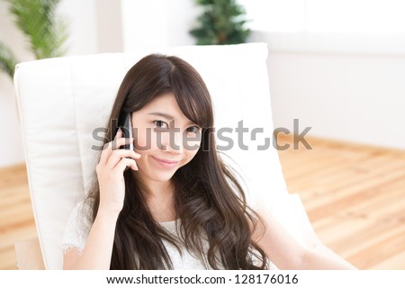 The Young woman who talks on the telephone in a room
