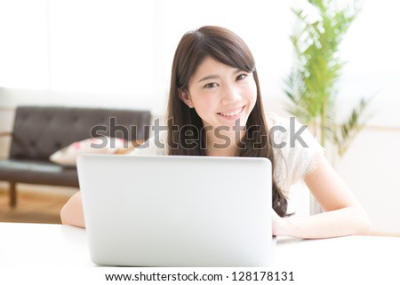 The Young woman who uses the computer in a room