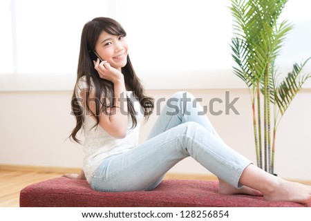 The Young woman who talks on the telephone in a room