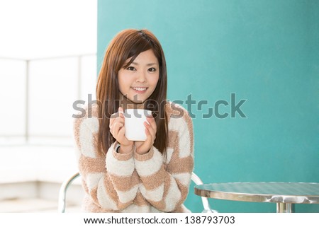 young asian woman relaxing in cafe