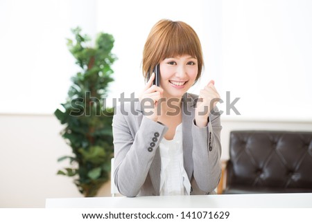 The Young businesswoman who talks on the telephone