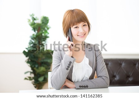 The Young businesswoman who talks on the telephone