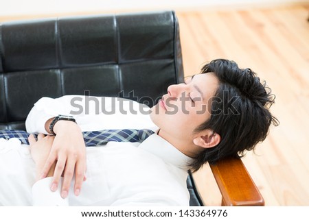 businessman who lies in the sofa