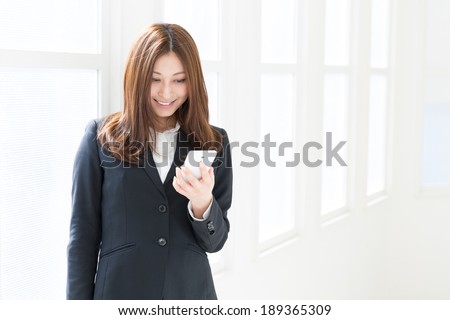 Beautiful young asian woman who see a smart phone