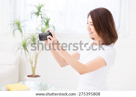 young attractive asian woman who takes a photograph