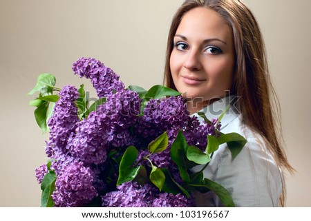 The beautiful woman with spring bouquet of lilac