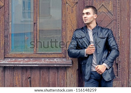portrait of the brutal young man in a leather jacket