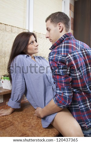 Portrait of a young couple having sex in the kitchen