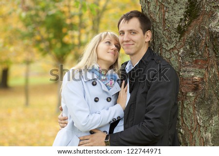 Picture of happy people spending fun time together in beautiful autumn park