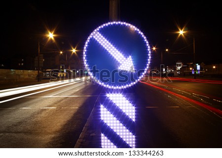 direction indicator and light trails on the modern city street at night