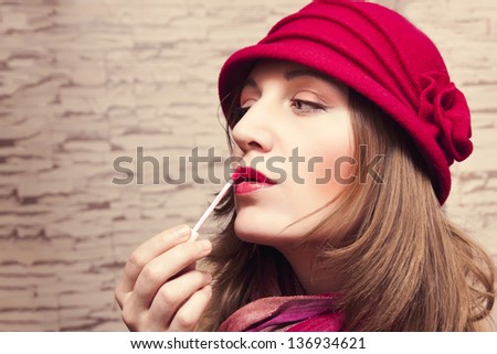 Pretty girl paint her lips lip gloss