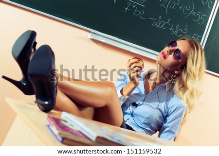 Beautiful young sexy teacher resting between the classes
