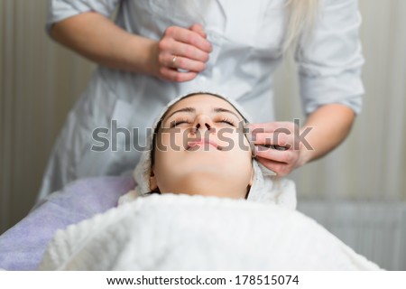 skin care, medical beautician removes the mask from the face of the girl