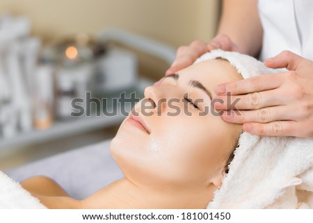 skin care, medical beautician makes massage face after applying mask