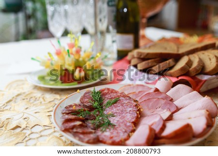 Dish with sliced meat products on the festive table