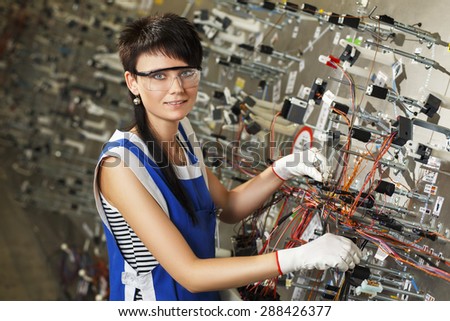 HRODNA, BELARUS - JULY 11, 2014 portrait of a woman working on electronic factory