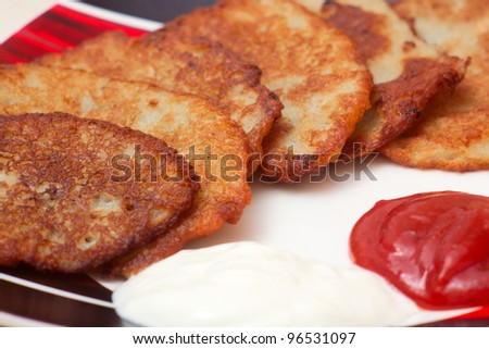 Potato pancake sour cream ketchup plate white