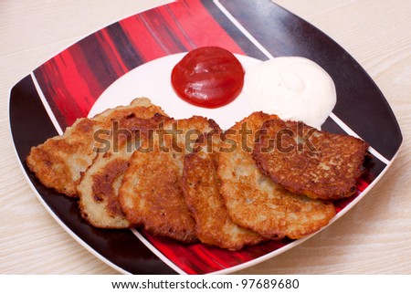 Potato pancake sour cream ketchup plate white