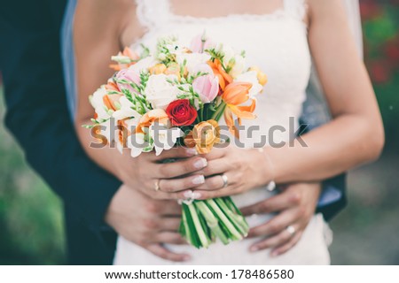 Wedding bouquet in hands of bride outdoors