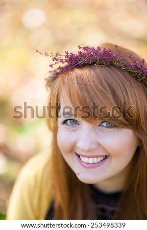 Beautiful girl with flowers wreath smiling, autumn colors