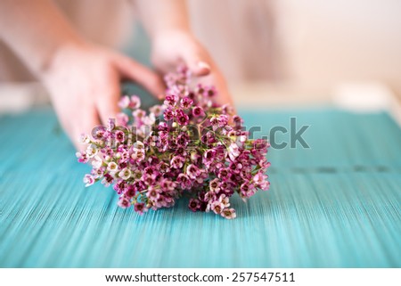 Florist making  wax flowers bouquet